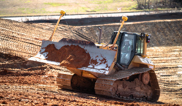 Bulldozer Moving Dirt At Job Site