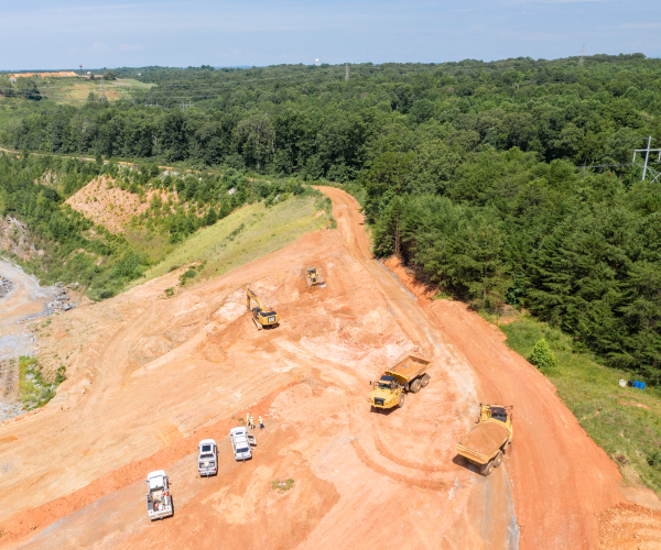Aerial View Of Heavy Equipment, Trucks & Contour Crew At Job Site