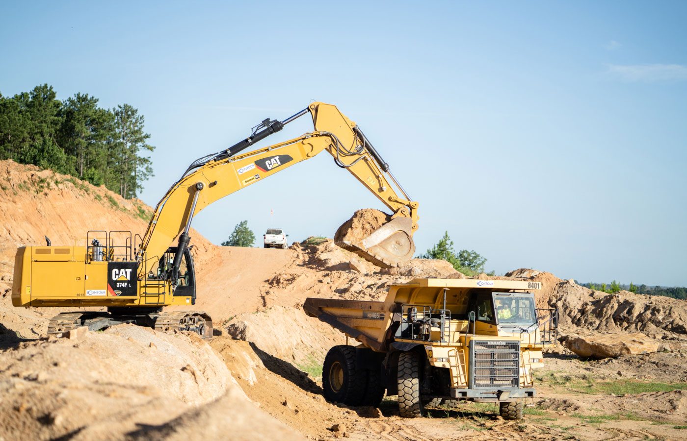 Cat 374f Loading Dirt Onto Dump Truck At Mass Excavation Job Site