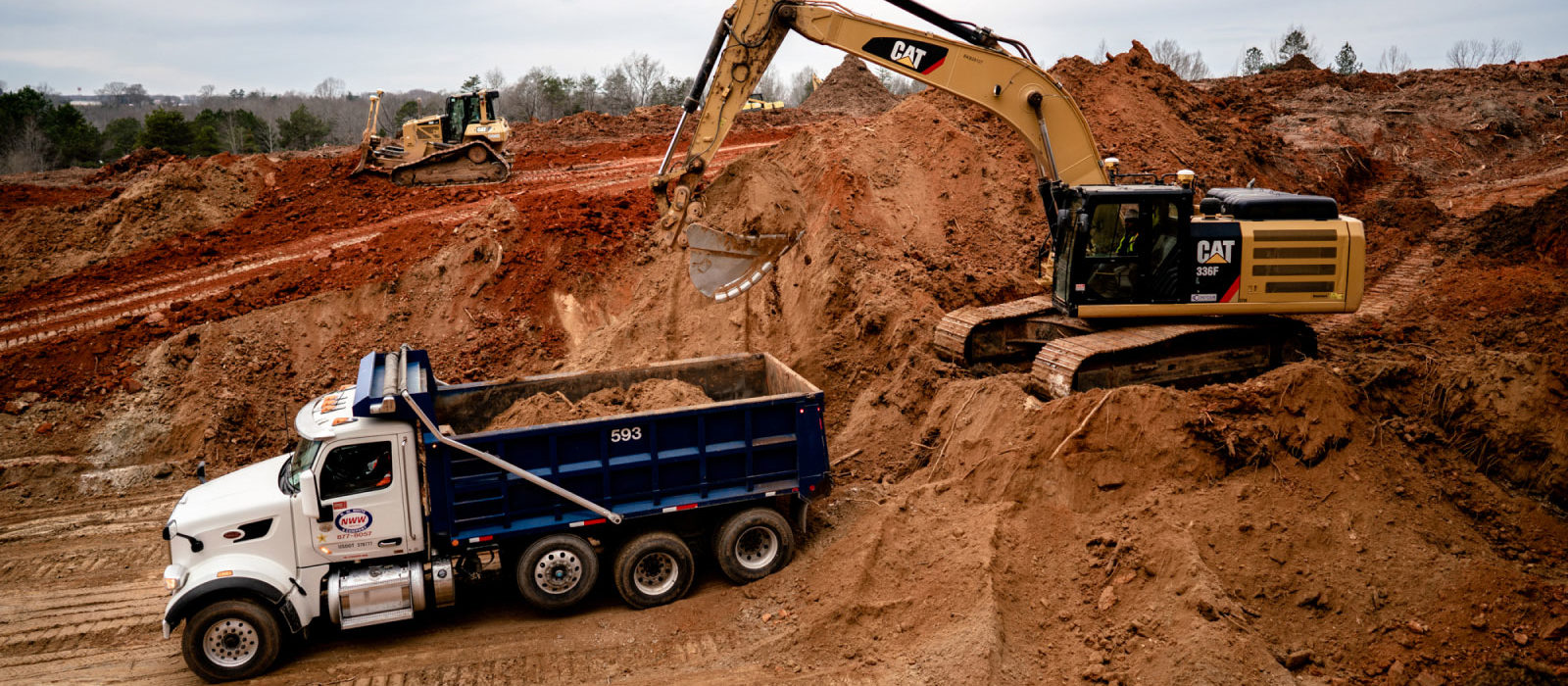 Cat 336f Loading Dirt Onto Dump Truck At Mass Excavation Job Site