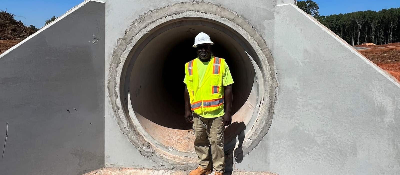 Project-Industrial-Blackstock Commerce Center-Man in hard had and safety vest standing in a pipe